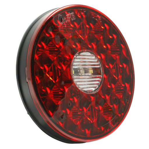 Red round reflective safety light on a white background