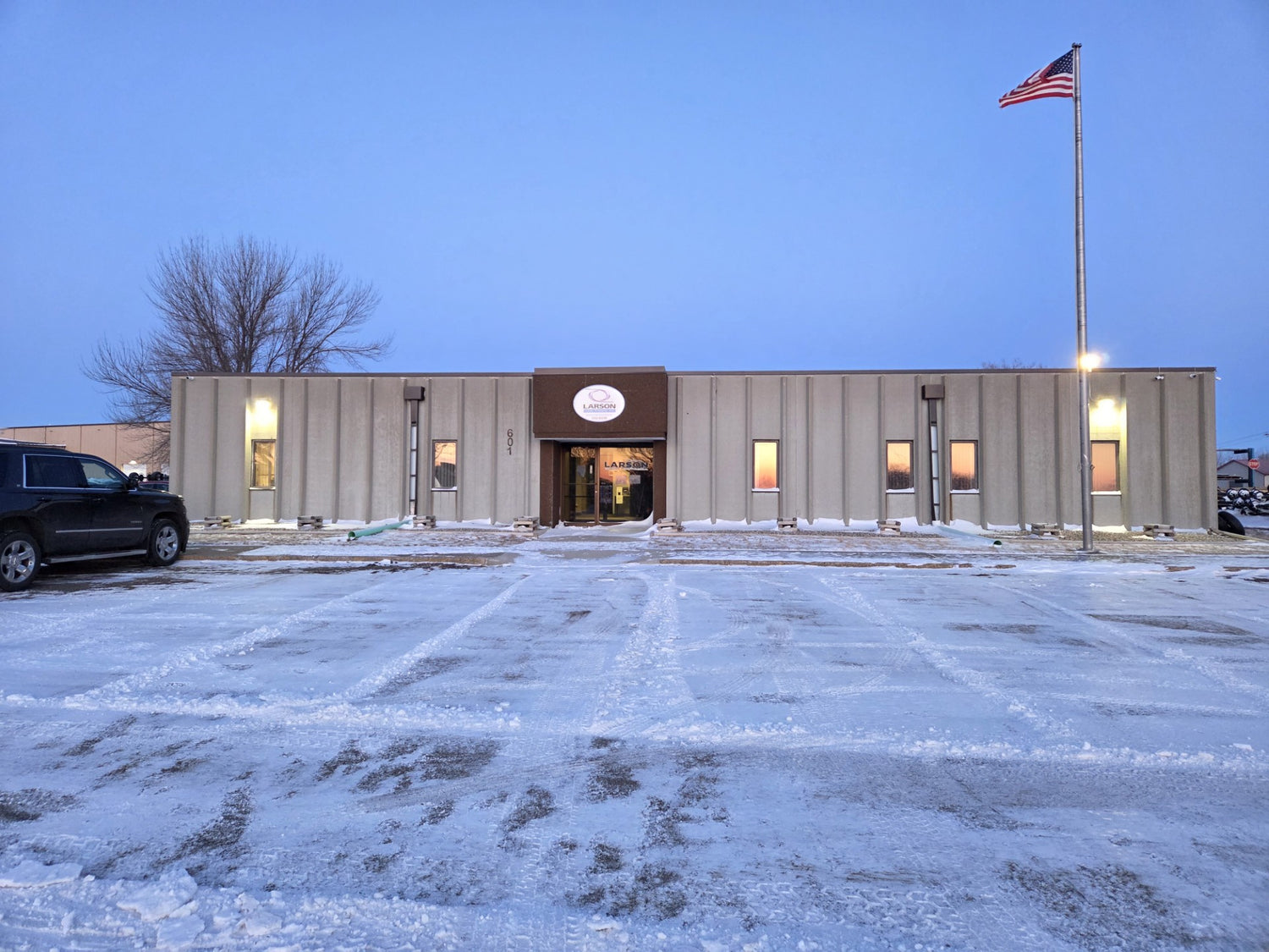 Commercial building with a flagpole and American flag on a clear day